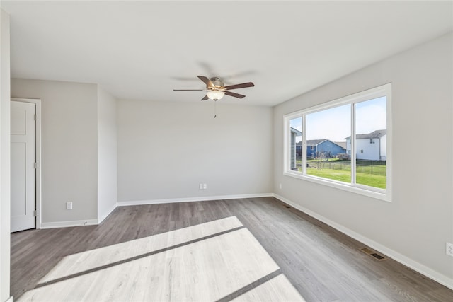 spare room featuring light hardwood / wood-style flooring and ceiling fan