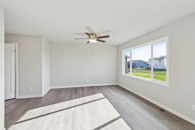 2009 White Oak Ln, Granger, IA 50109 - empty room with ceiling fan, wood finished floors, and baseboards