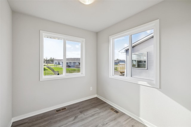 2009 White Oak Ln, Granger, IA 50109 - spare room with healthy amount of natural light, light wood-type flooring, and baseboards