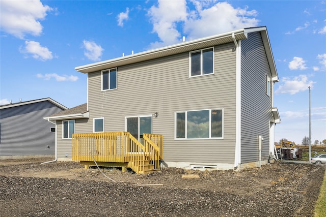 rear view of house featuring a wooden deck