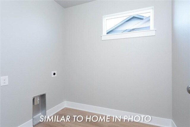 washroom featuring hardwood / wood-style flooring and electric dryer hookup