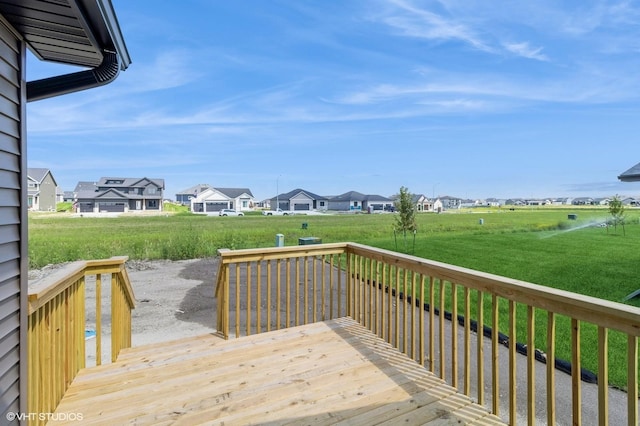 wooden deck with a residential view and a lawn