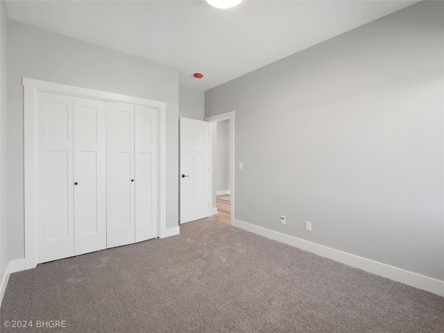 unfurnished bedroom featuring a closet and carpet floors