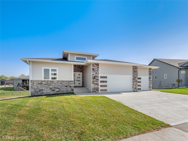 view of front of house with a front lawn and a garage