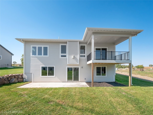 back of property featuring a patio area and a lawn