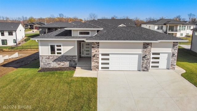 prairie-style home featuring a garage and a front yard