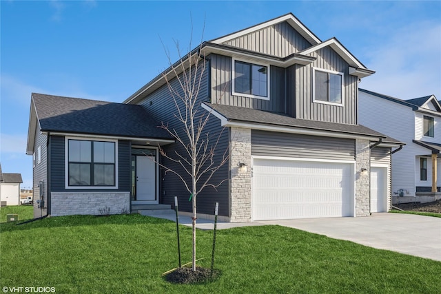 view of front of home with a front yard and a garage