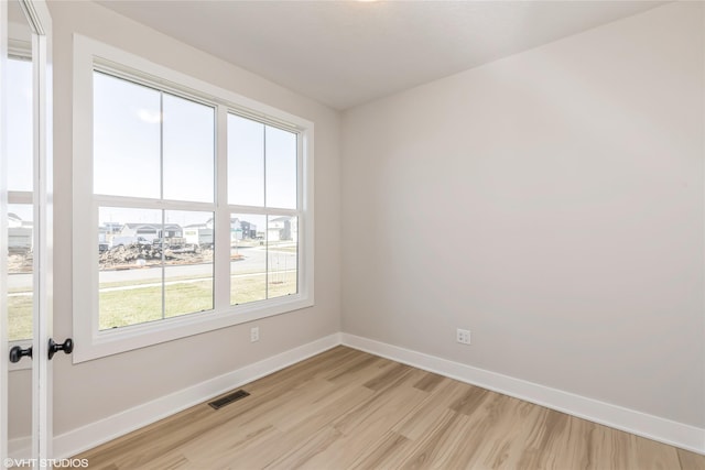 empty room with light hardwood / wood-style floors