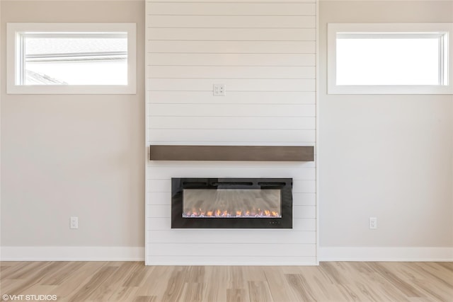 interior details featuring hardwood / wood-style floors and a fireplace