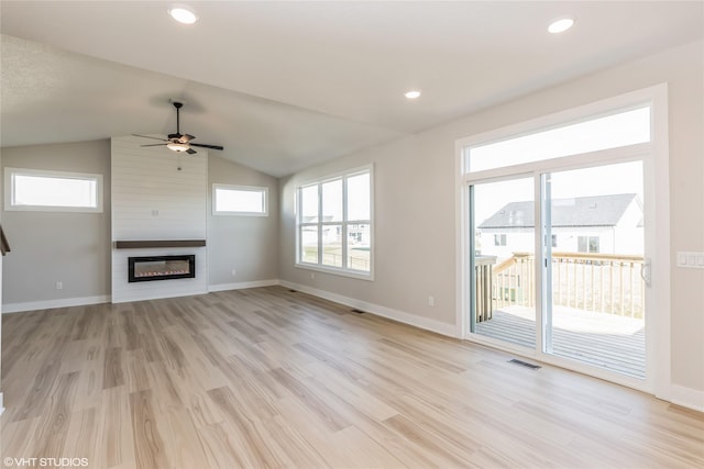 unfurnished living room with a fireplace, ceiling fan, light hardwood / wood-style flooring, and vaulted ceiling