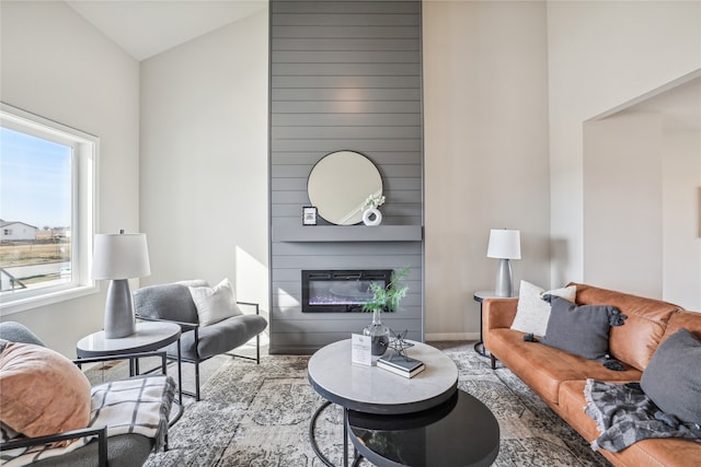 living room with a large fireplace and lofted ceiling