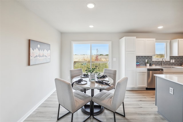 dining room featuring recessed lighting, baseboards, and light wood-style floors