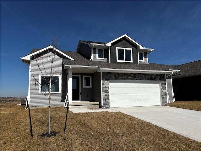 view of front of home featuring central air condition unit, an attached garage, stone siding, and driveway