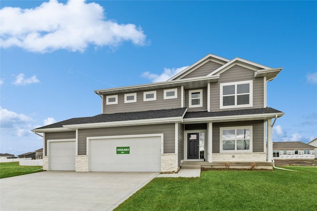 craftsman-style home with a porch, a front yard, and a garage