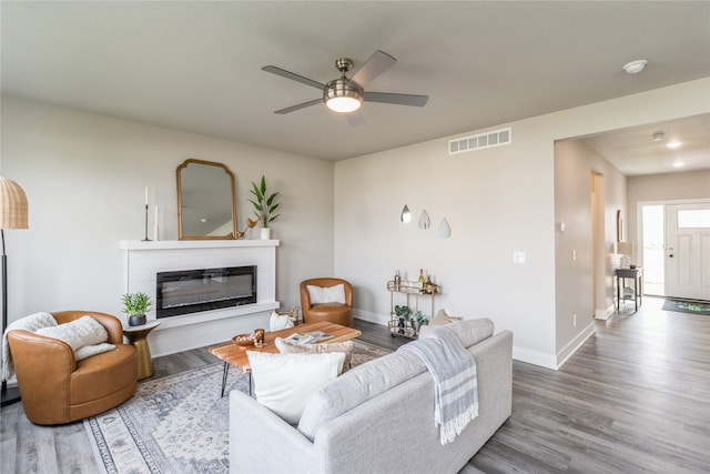 living room featuring ceiling fan and wood-type flooring