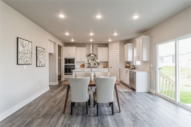 dining room with dark hardwood / wood-style floors and sink