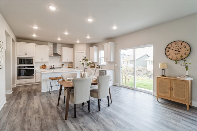 dining area with sink and wood-type flooring