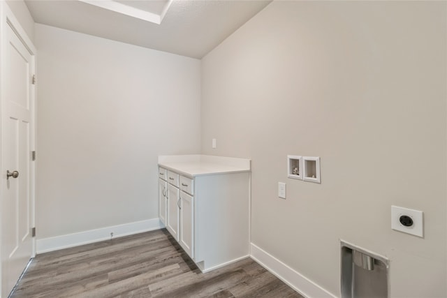 clothes washing area featuring cabinets, washer hookup, light wood-type flooring, and electric dryer hookup