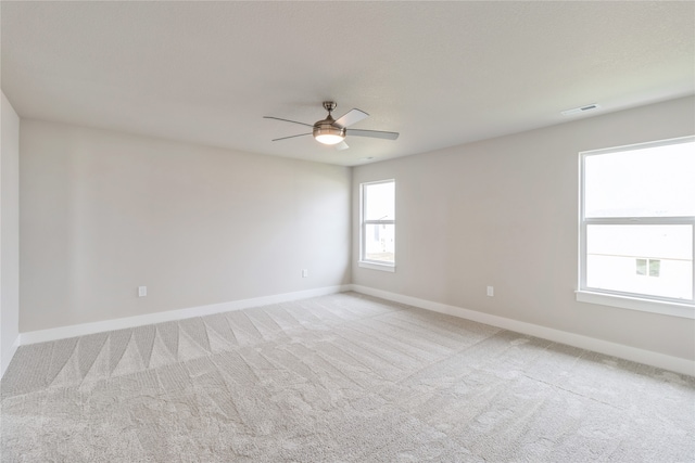 unfurnished room with light carpet and ceiling fan