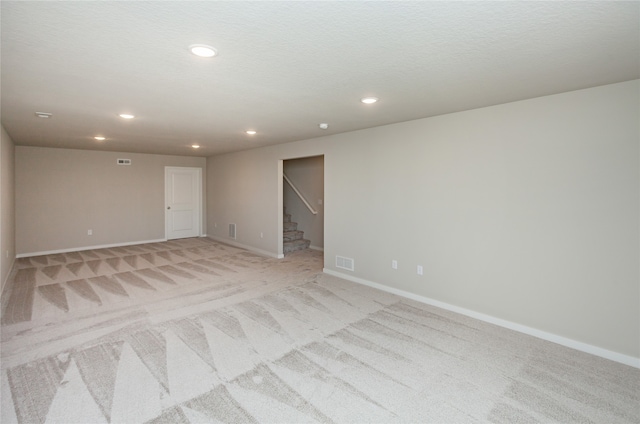 unfurnished room featuring light carpet