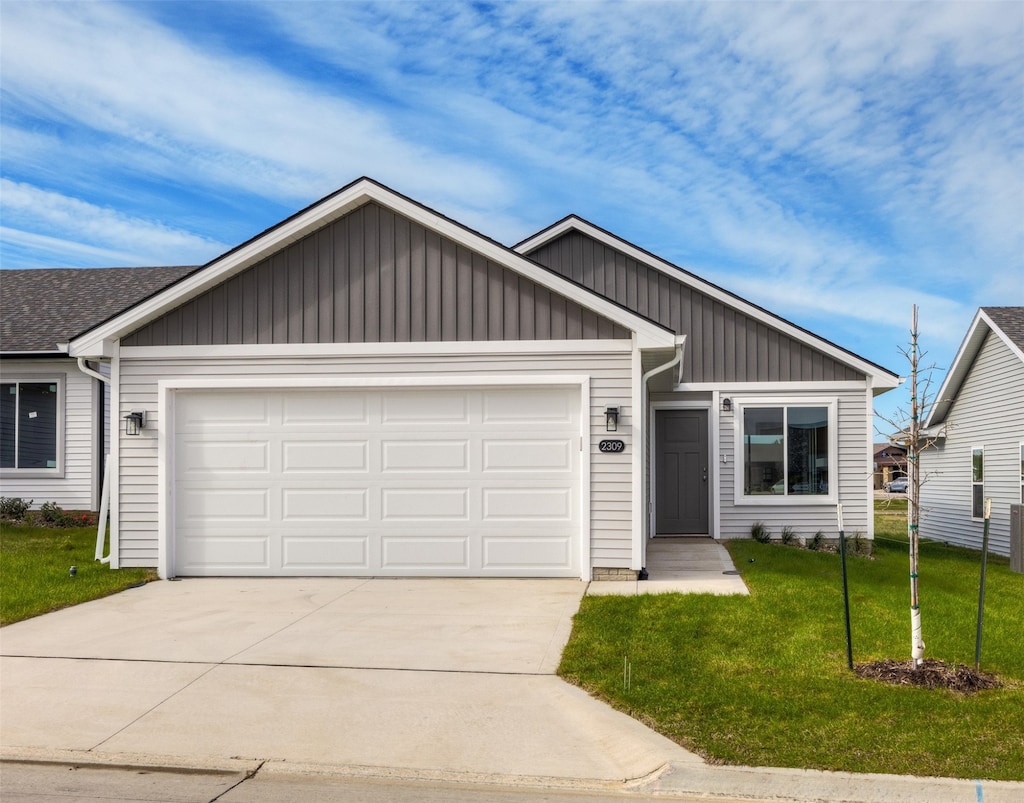 view of front of property featuring a garage and a front lawn