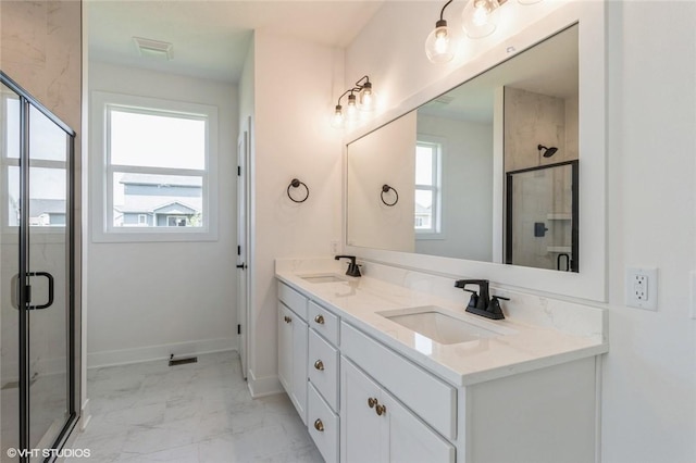 bathroom with vanity and a shower with shower door