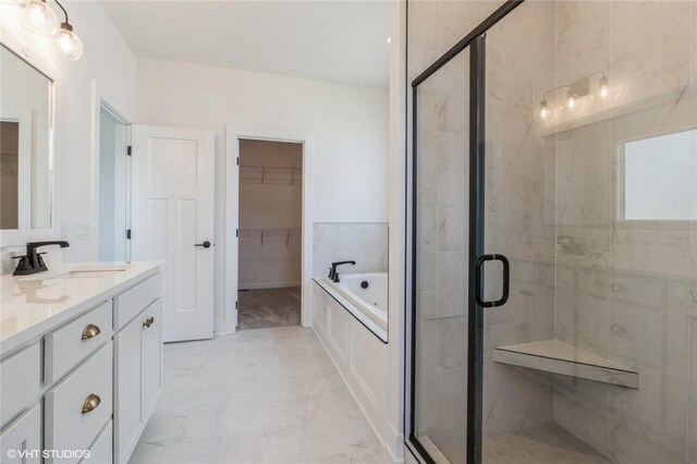 bathroom featuring vanity and separate shower and tub