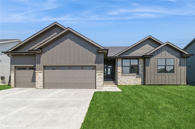 view of front of home featuring a front yard and a garage