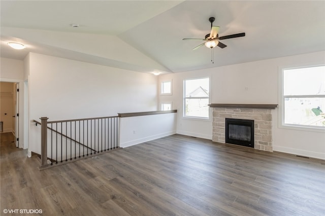 unfurnished living room with lofted ceiling, dark wood-type flooring, a fireplace, and ceiling fan