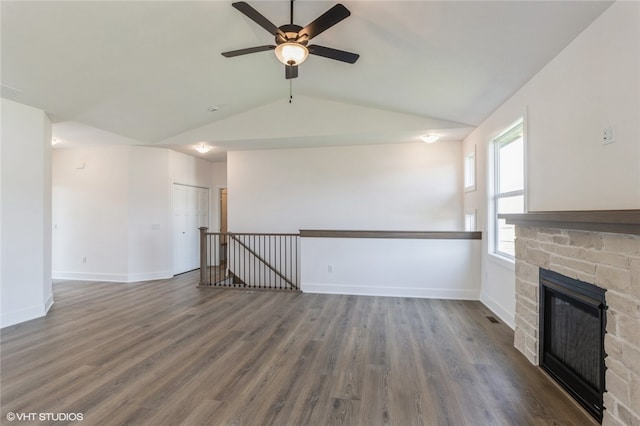 unfurnished living room featuring lofted ceiling, a fireplace, and dark hardwood / wood-style floors