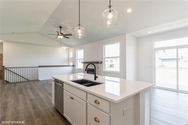 kitchen featuring sink, an island with sink, dishwasher, white cabinetry, and lofted ceiling