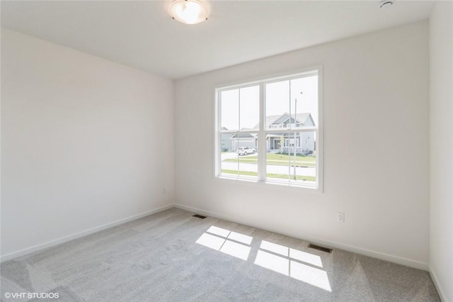 empty room featuring light carpet