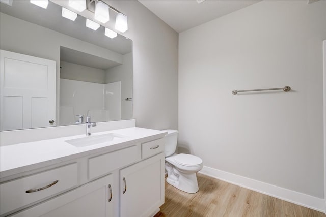 bathroom featuring a shower, hardwood / wood-style floors, vanity, and toilet