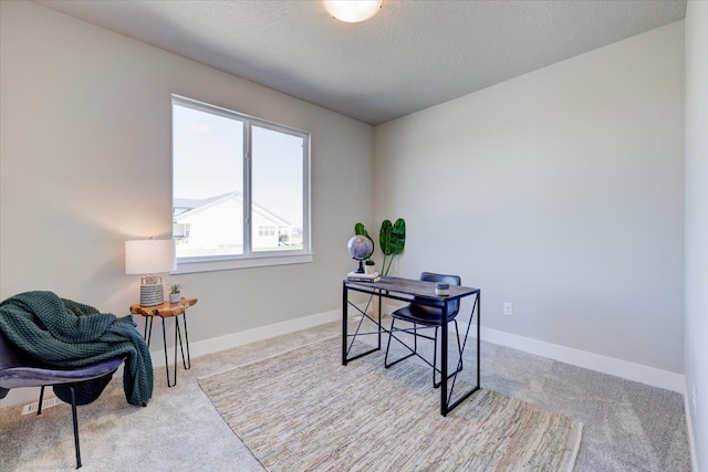 carpeted office space with a textured ceiling