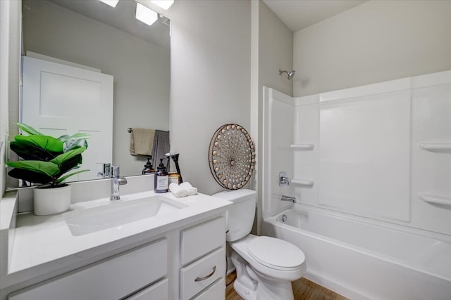 full bathroom featuring toilet, vanity, wood-type flooring, and tub / shower combination