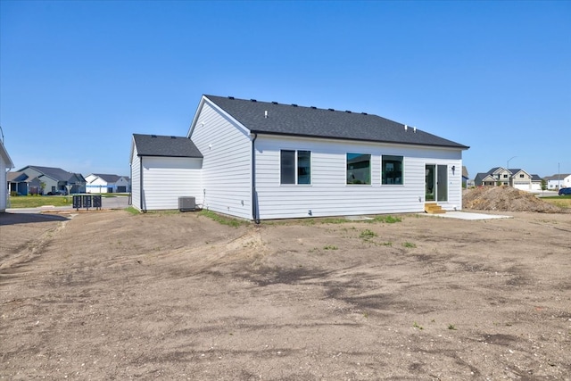 rear view of house featuring central AC unit