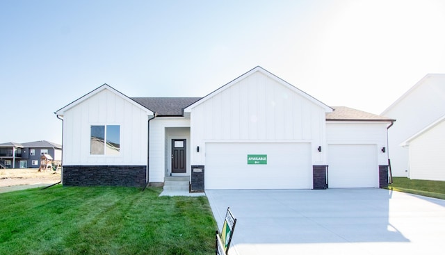 modern inspired farmhouse with a garage and a front yard