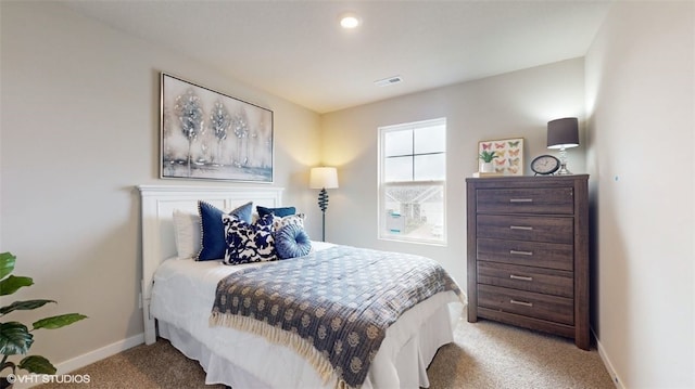 carpeted bedroom featuring visible vents and baseboards