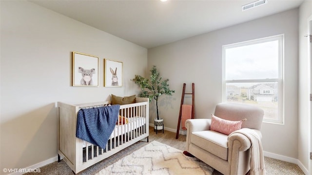 carpeted bedroom featuring a crib