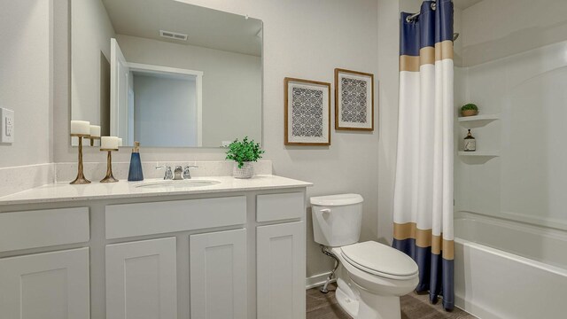 full bathroom featuring toilet, vanity, and shower / bath combo with shower curtain