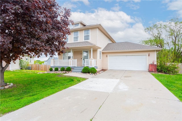 view of property with a garage, a front lawn, and covered porch