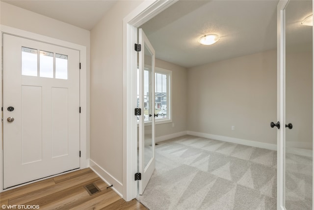 entrance foyer with a healthy amount of sunlight and light wood-type flooring