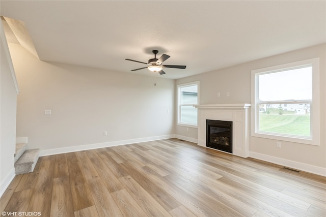 unfurnished living room featuring light hardwood / wood-style flooring and ceiling fan