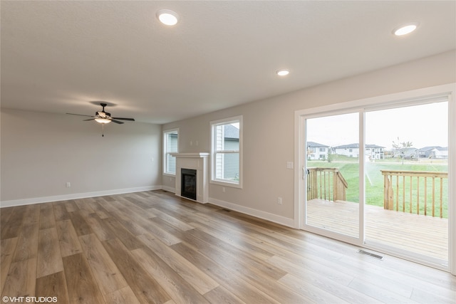 unfurnished living room featuring light wood-type flooring and ceiling fan