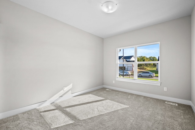 unfurnished room featuring carpet