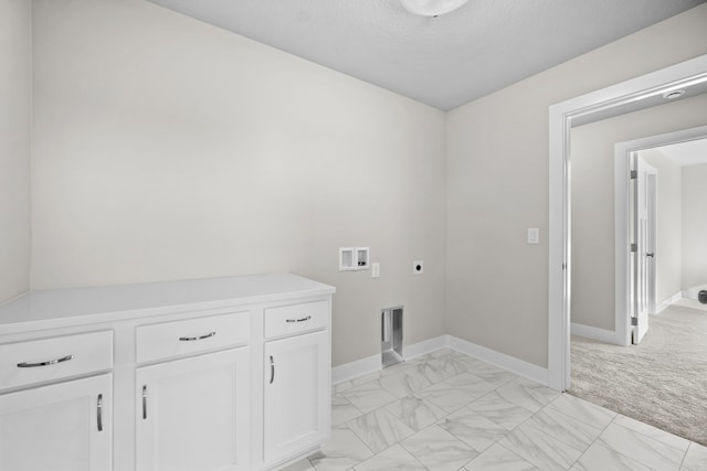 laundry area featuring cabinets, washer hookup, hookup for an electric dryer, light colored carpet, and a textured ceiling