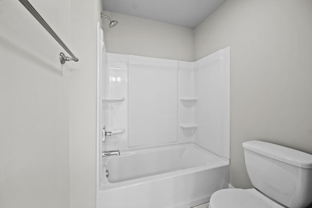 bathroom with bathtub / shower combination and toilet