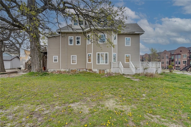 rear view of property featuring a lawn