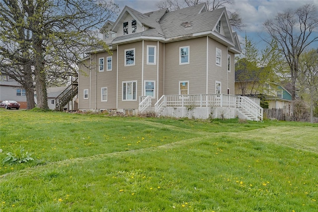 back of house with a lawn