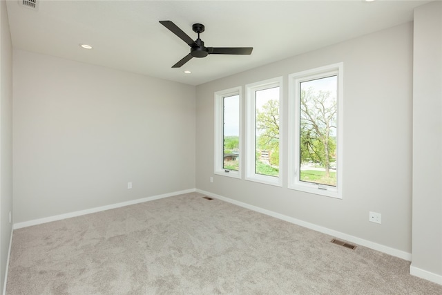 empty room featuring ceiling fan and carpet flooring